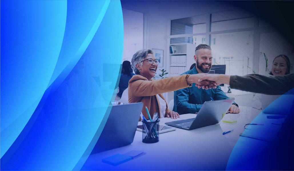 A smiling procurement team meeting with a client
