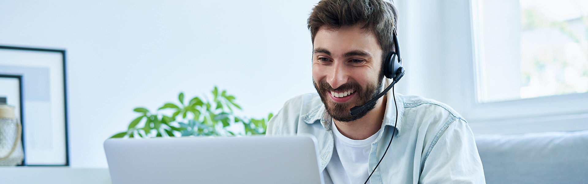 Man working from home talking on a headset