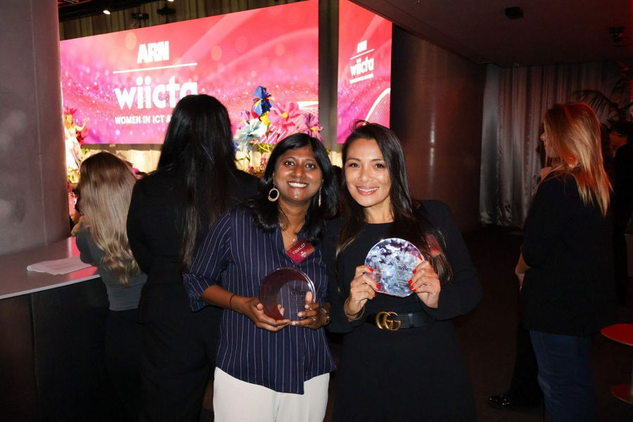 Girlie Brotonel and Lakshmi Muthaiah at the Women in ICT Awards 2026 ceremony, standing to the side of the stage after receiving their awards.
