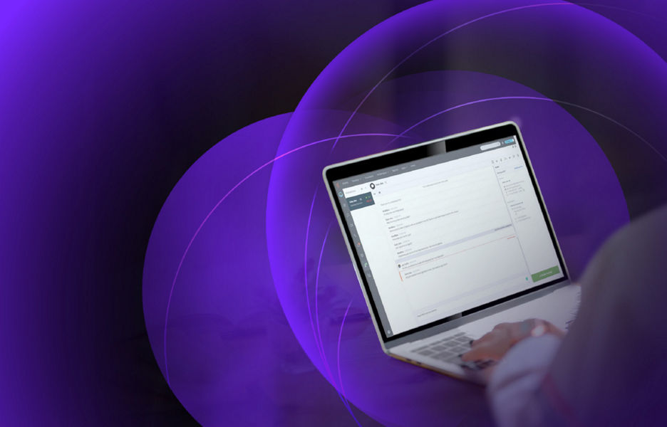 A person working on a laptop at a desk at home