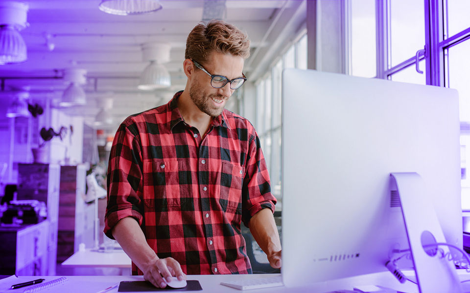 A young man building a website in an office