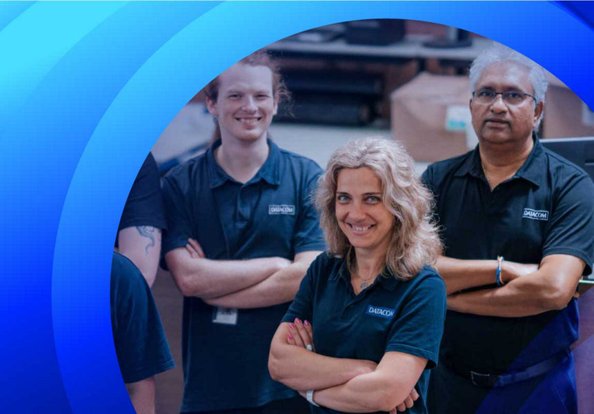 A group of Datacom employees smiling at the camera.