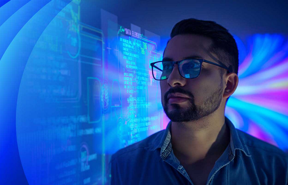 A man wearing glasses standing amongst data