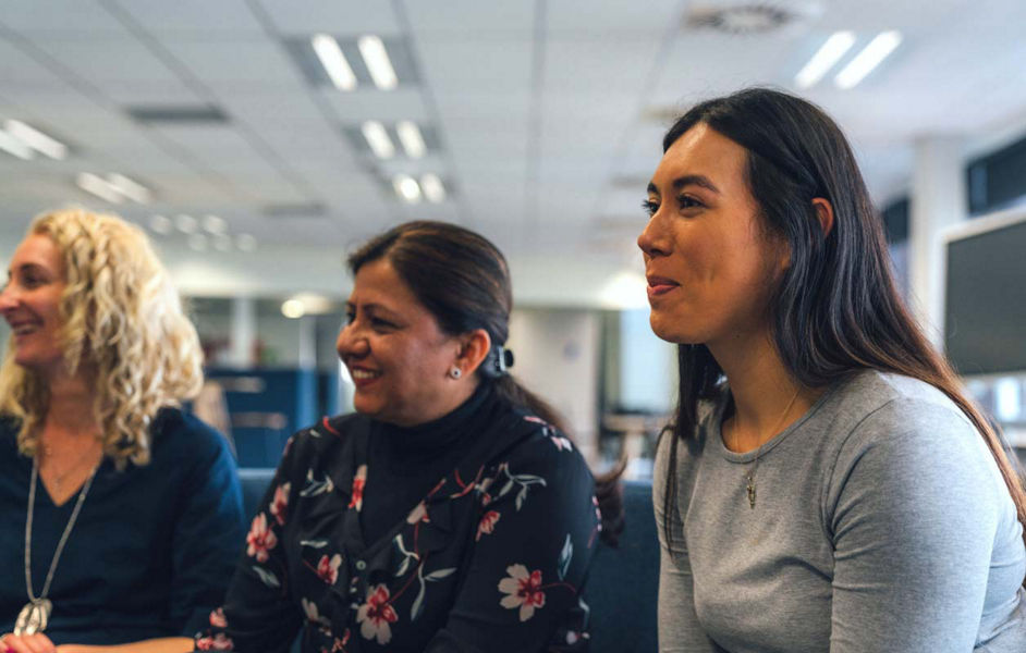 A group of diverse Datacom employees having a discussion