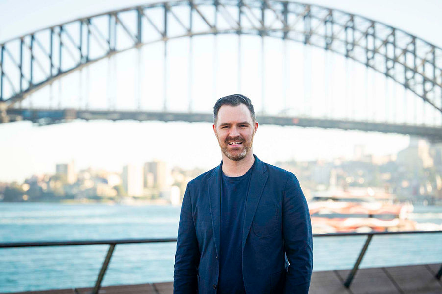 Photo of William Clancy in front of the Sydney harbour bridge
