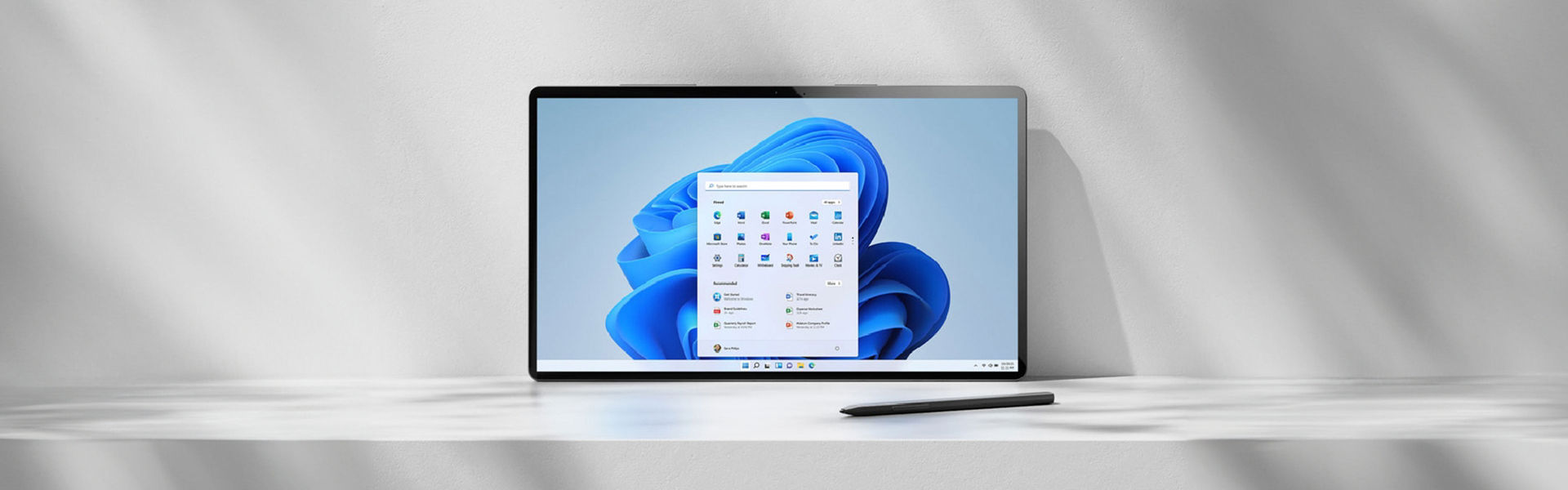 Screen sitting on ledge propped against white wall showing Windows 11 operating system