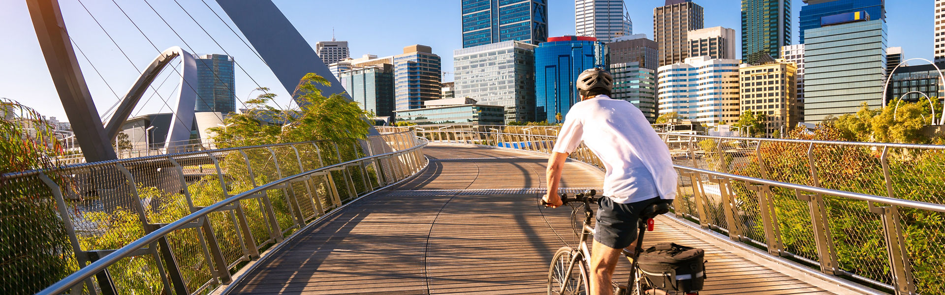 man riding a bike on a bridge in Pert