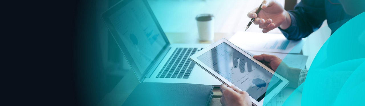 Hands using a tablet and laptop on Datapay branded banner