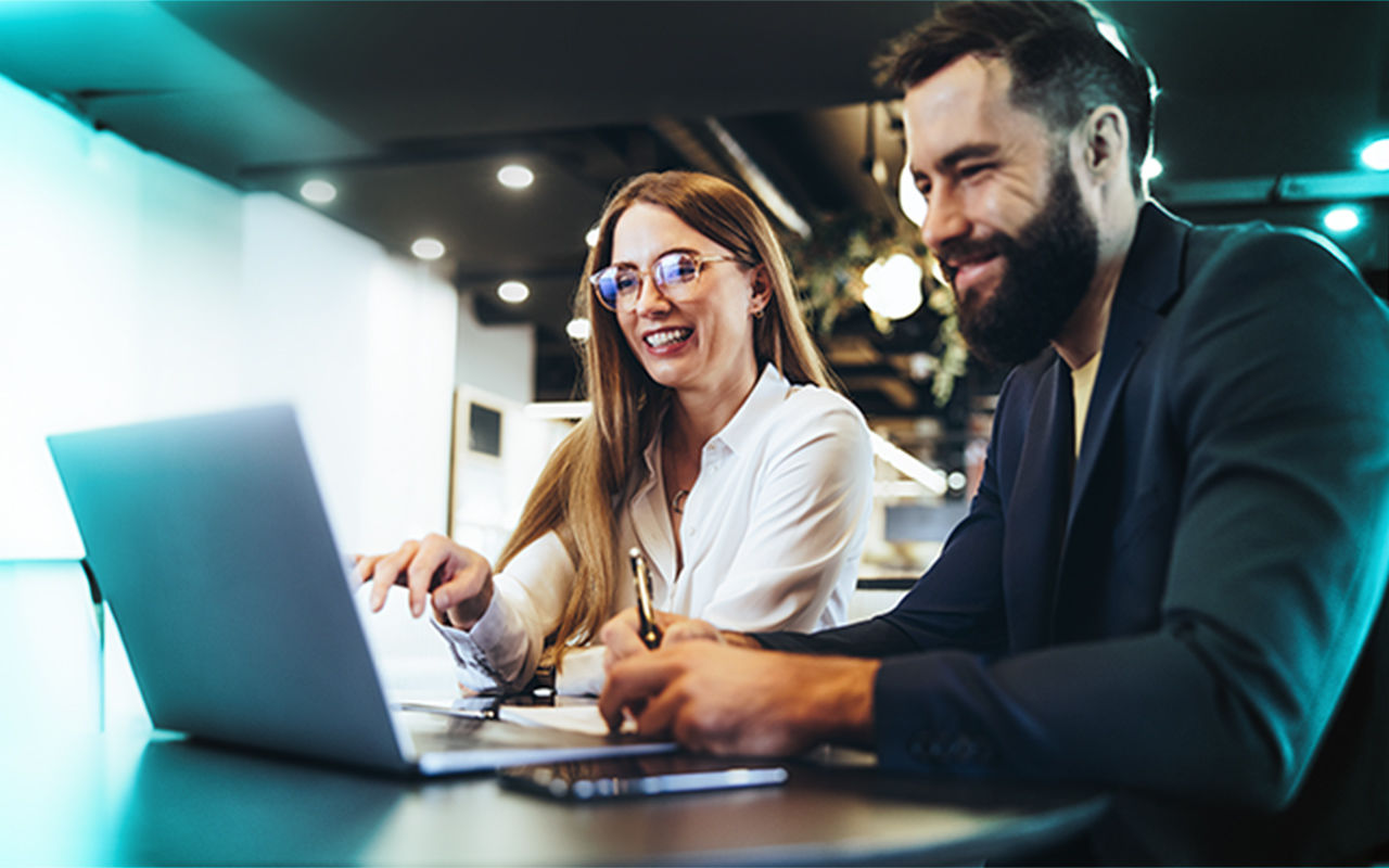 Woman and man looking at laptop