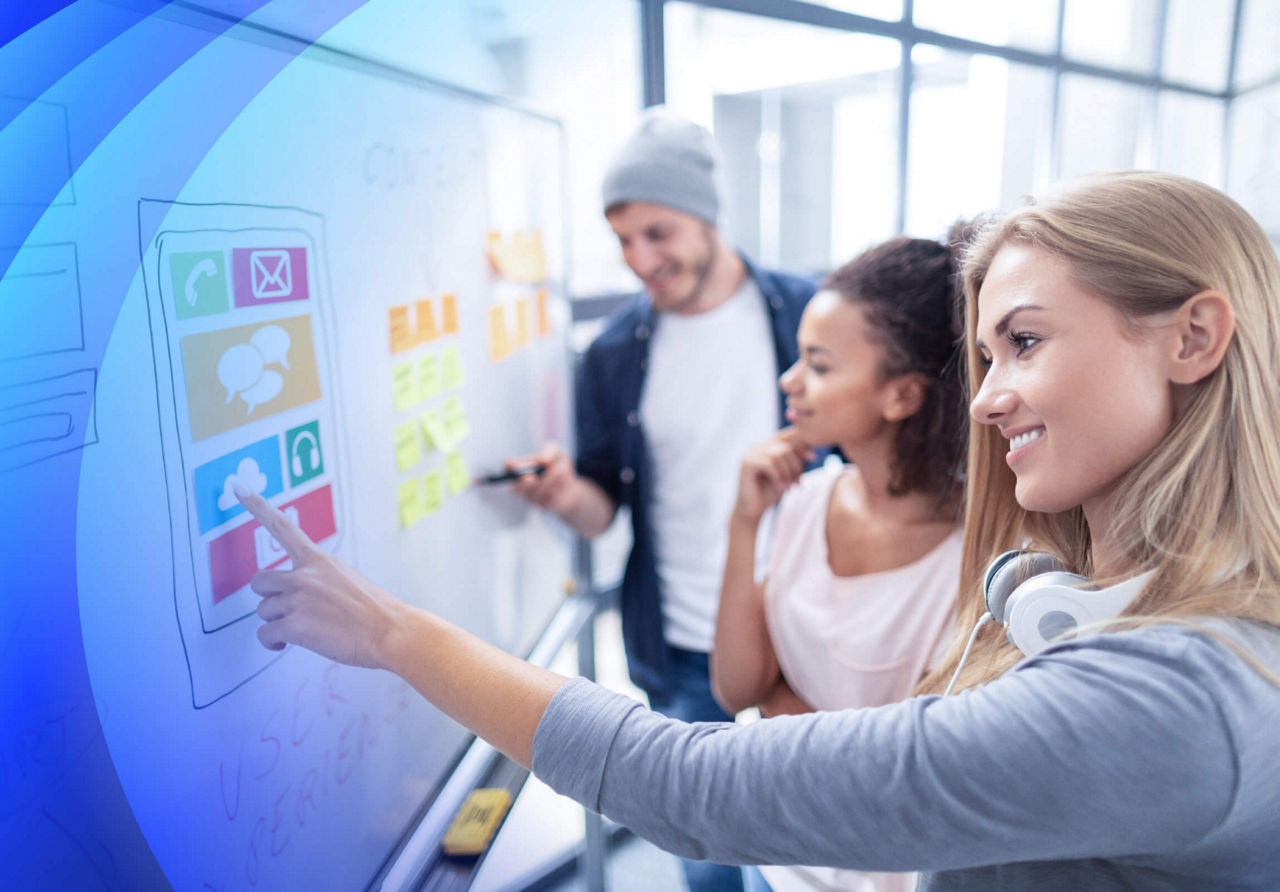 A group of designers working at a whiteboard