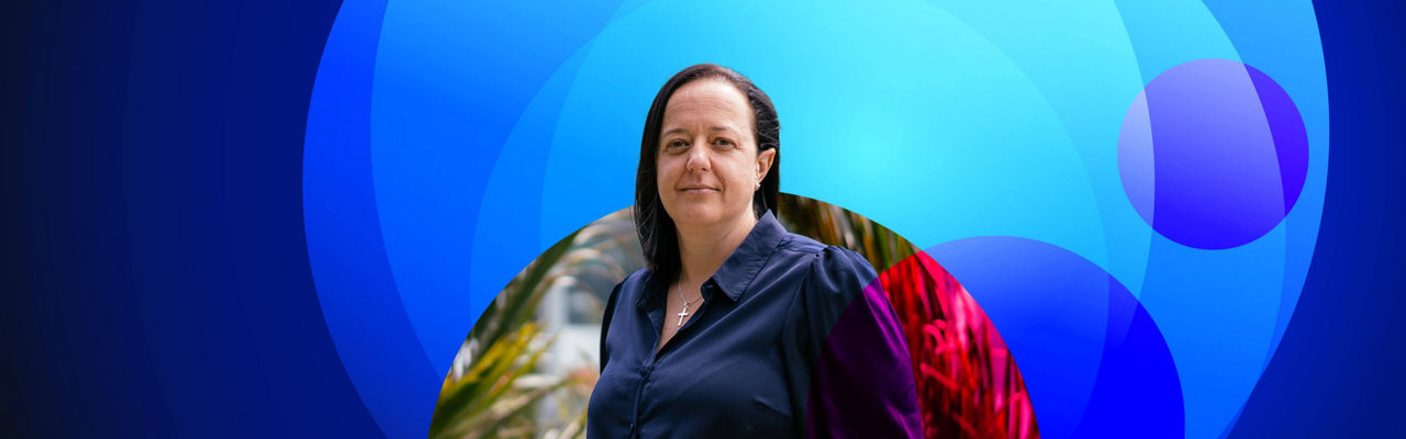 lady standing with Datacom's blue lens graphic in the background