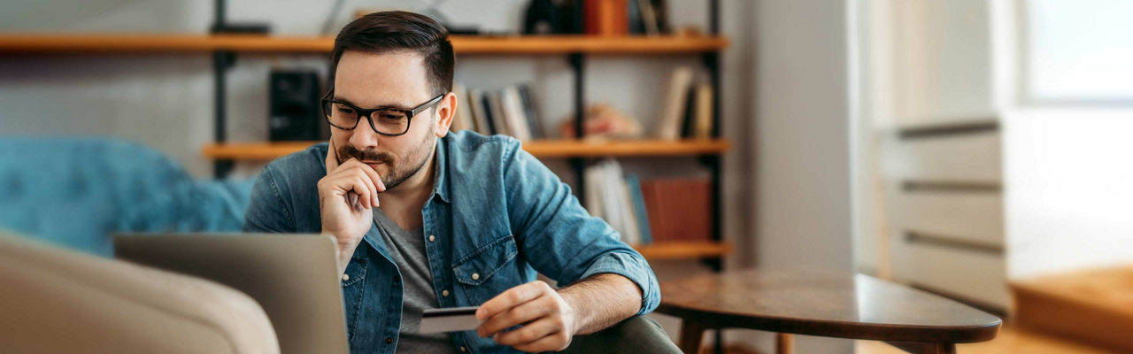 A man checking over his financials at home on a laptop