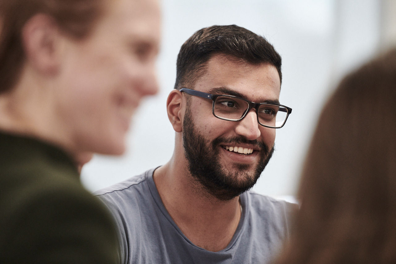 a smiling man wearing glasses