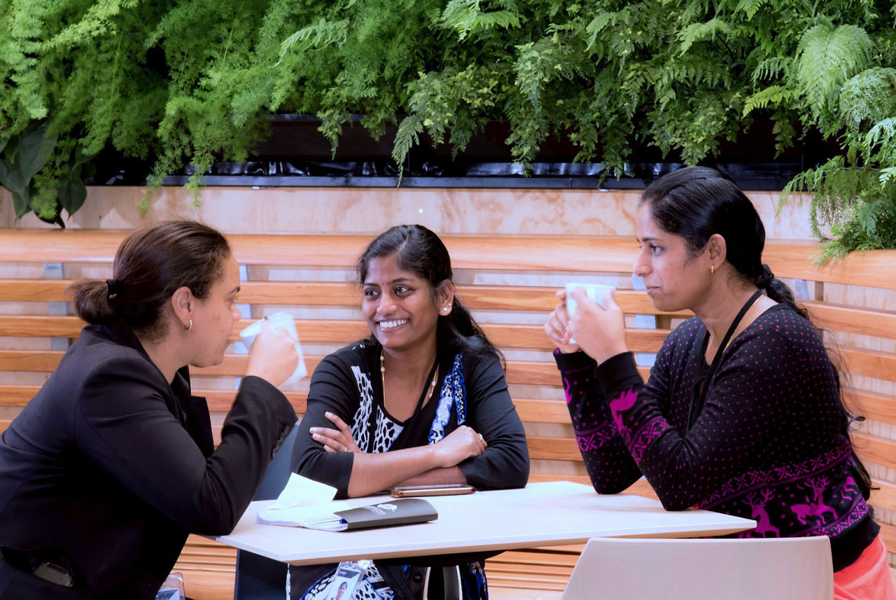 three ladies drinking coffee together