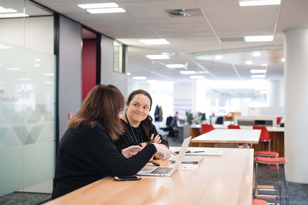 two ladies working at a desk