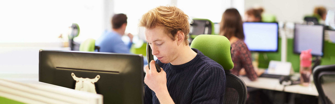 A call centre operator taking a call in a call centre