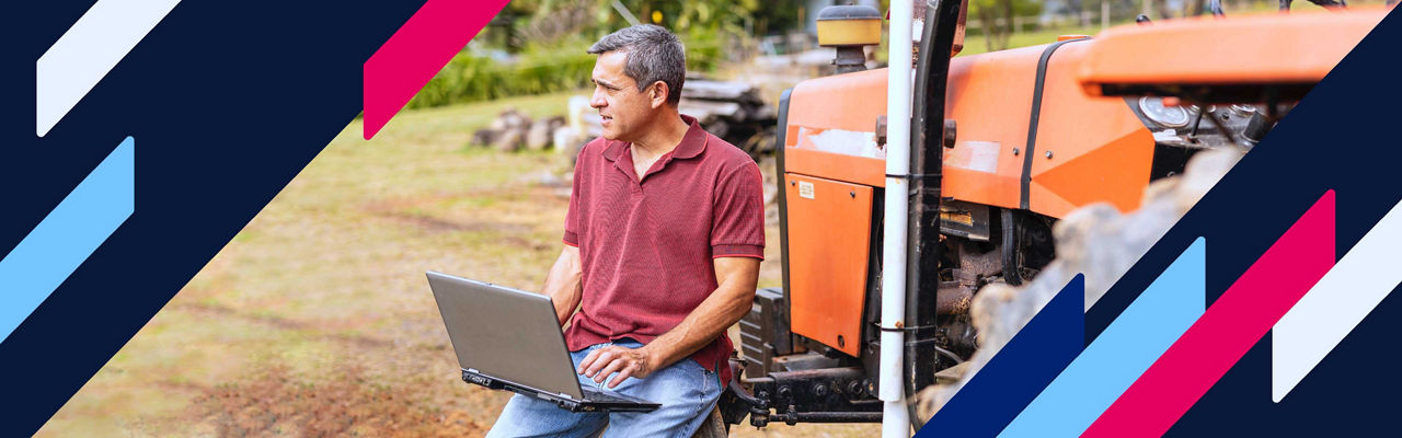 A man using a tablet in an orchard