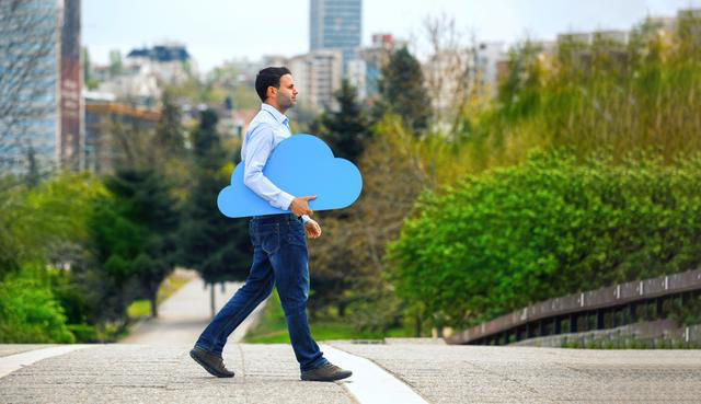 A man walking and holding a blue cloud in his hands
