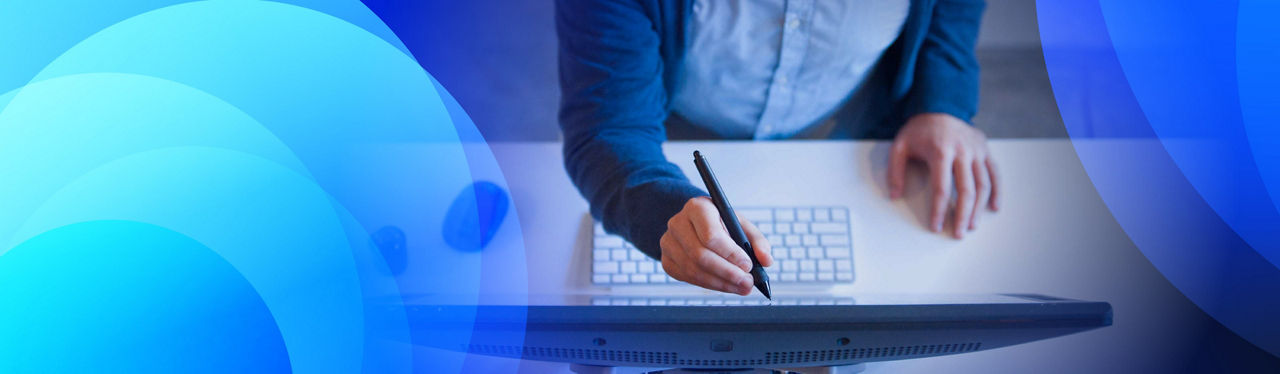 A person in a suit using s stylus to write on a monitor
