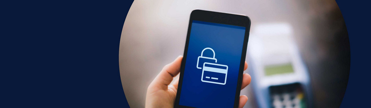 A person holding a phone with lock and credit card icons on it