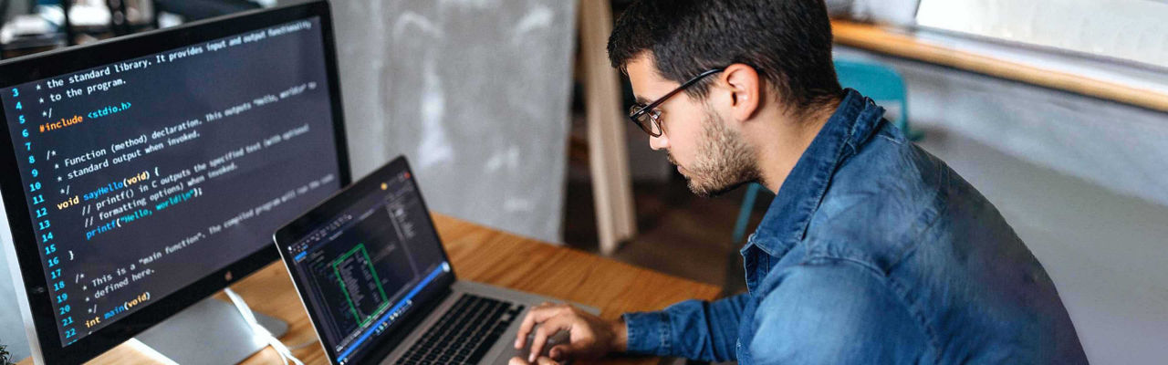Man coding on a laptop