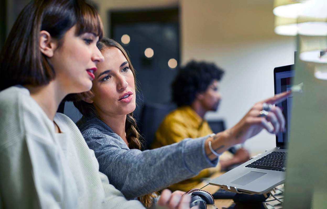 Officeworkers pointing at a screen