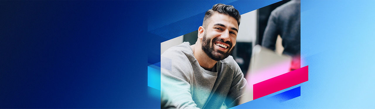 A smiling young man working in the office