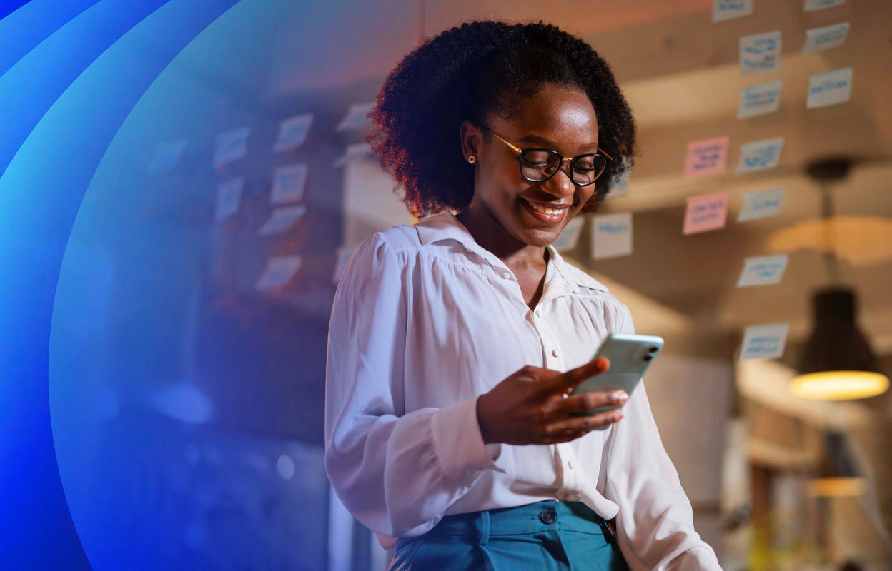 Woman smiling looking at a smartphone