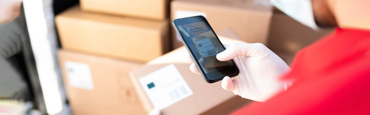 Mobile held in hand above packages