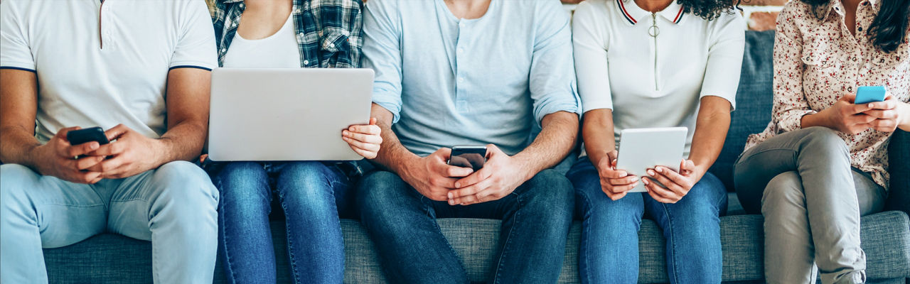 people sitting on couch using devices