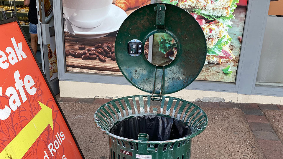 An open garbage bin on the street
