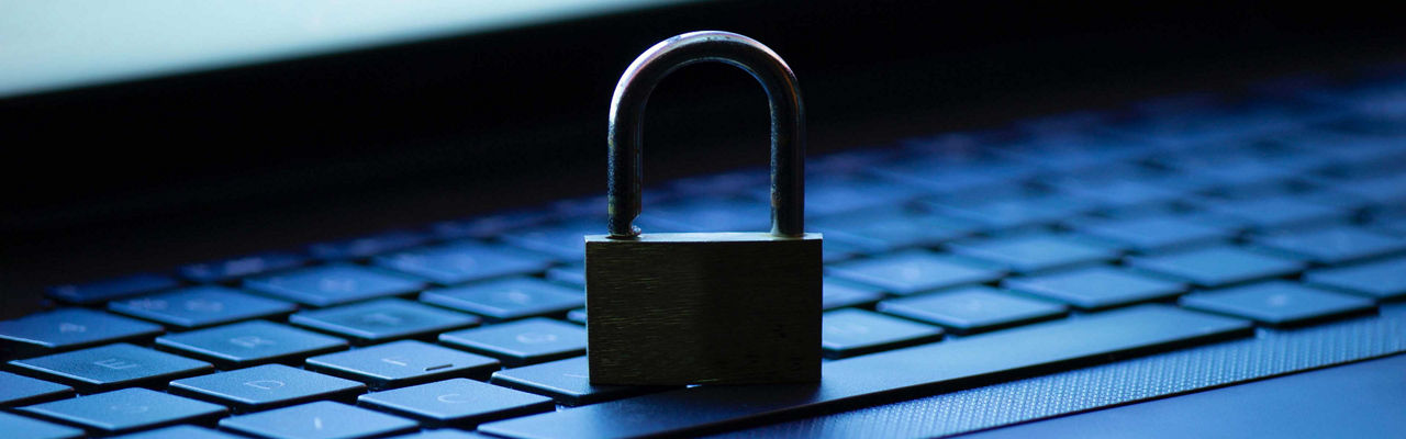 A padlock sitting on top of a laptop keyboard